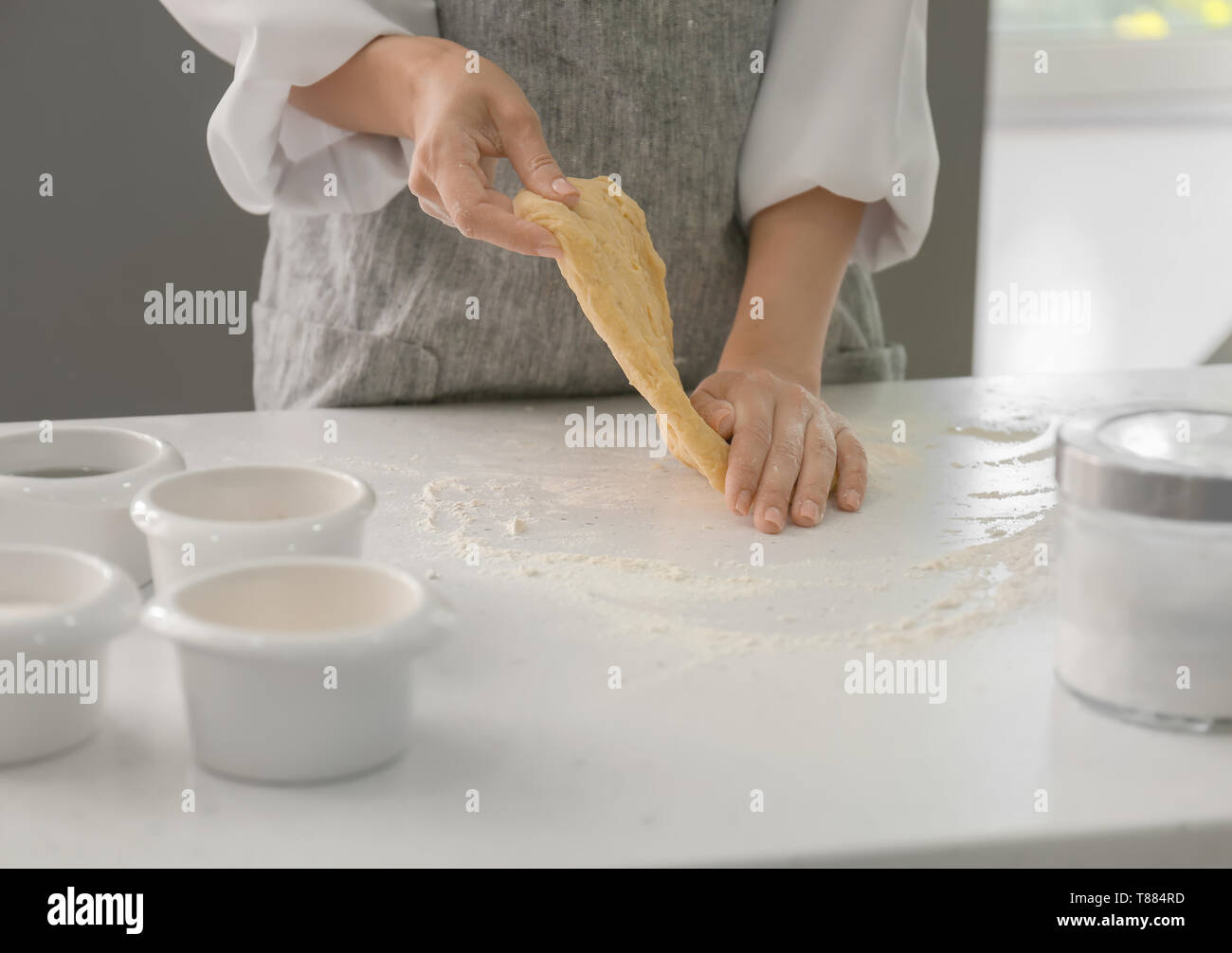 Woman kneading dough for bakery on kitchen table Stock Photo - Alamy