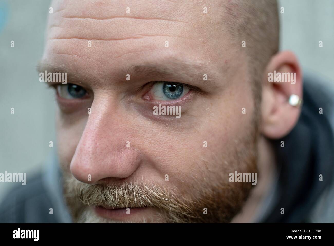 serious looking bearded man looks into the camera Stock Photo