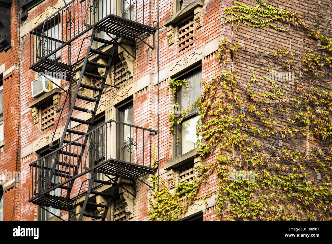 Close-up view of New York City style apartment buildings with emergency stairs along Mott Street in Chinatown neighborhood of Manhattan, New York, USA Stock Photo