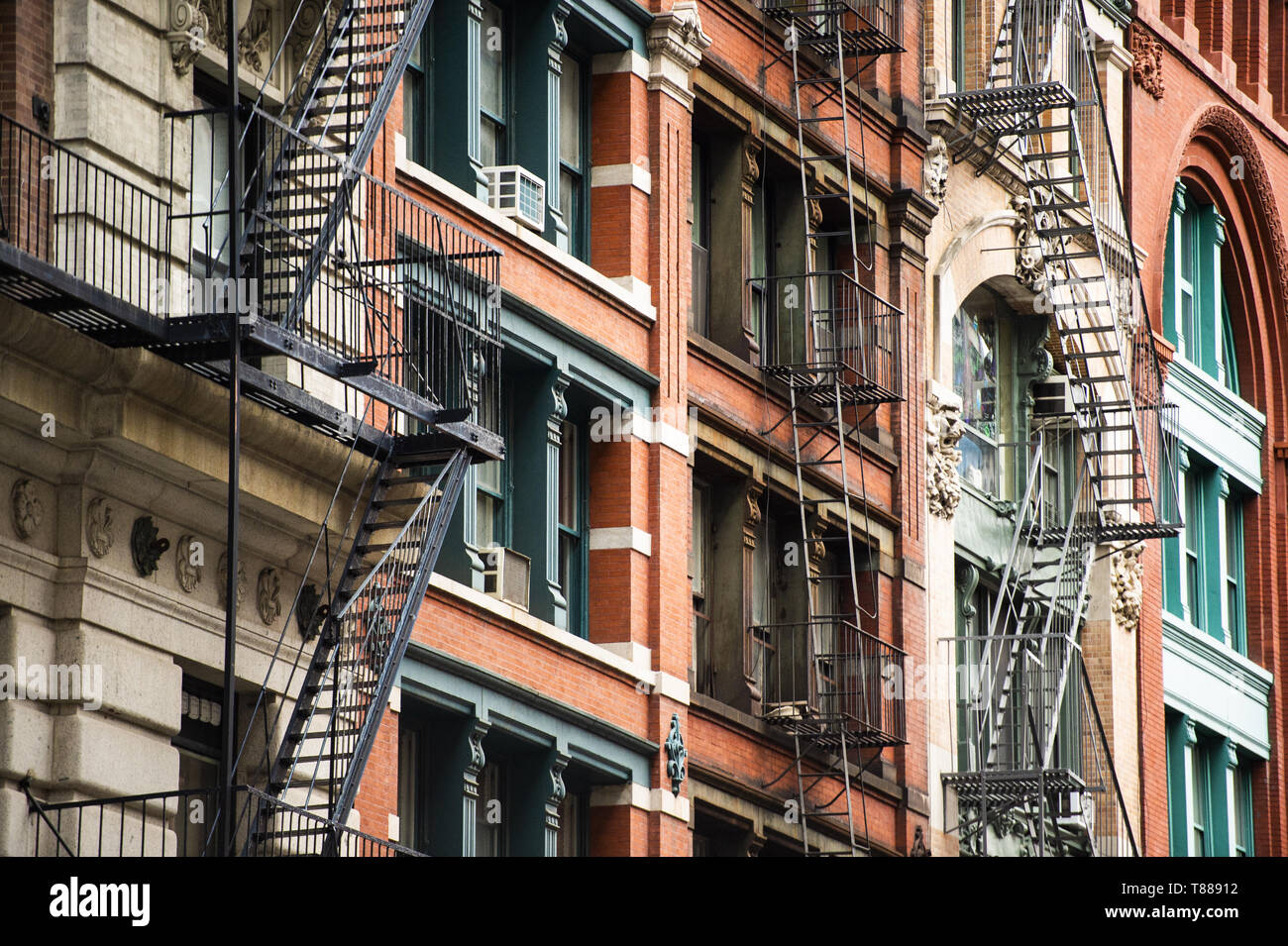 Close-up view of New York City style apartment buildings with emergency stairs along Mott Street in Chinatown neighborhood of Manhattan, New York, USA Stock Photo