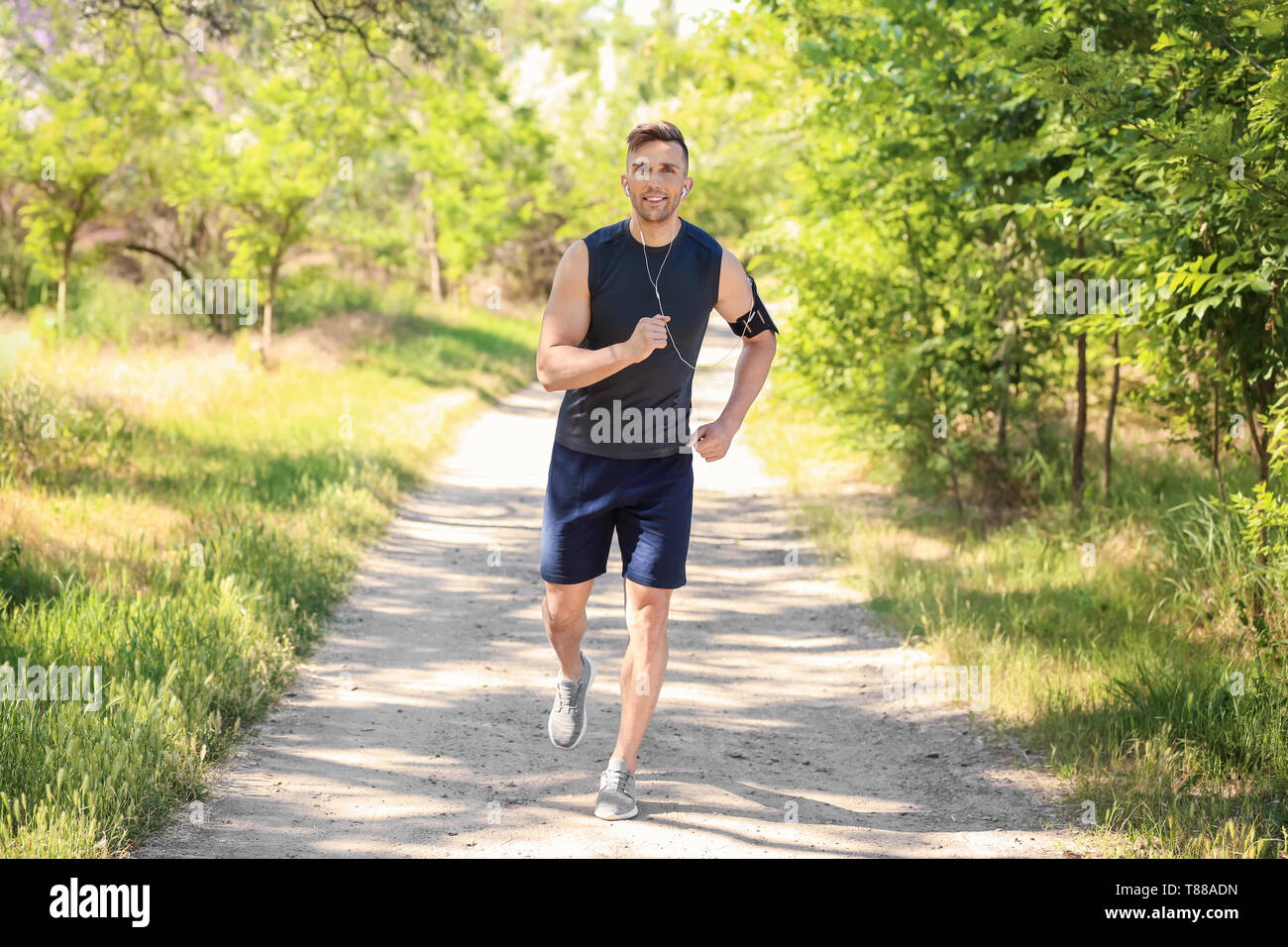 Sporty man running in park Stock Photo - Alamy