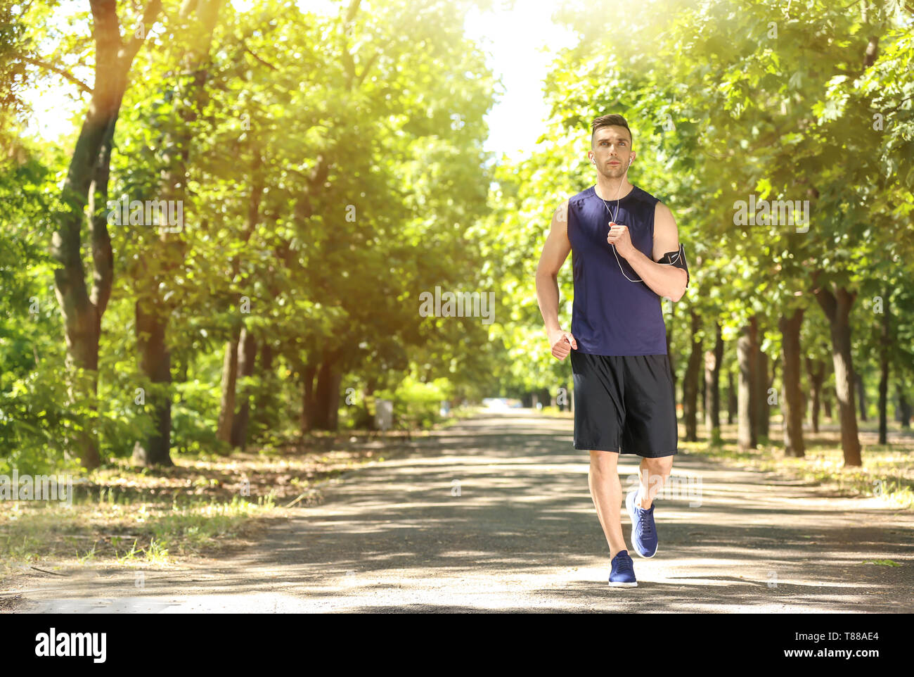 Sporty man running in park Stock Photo - Alamy