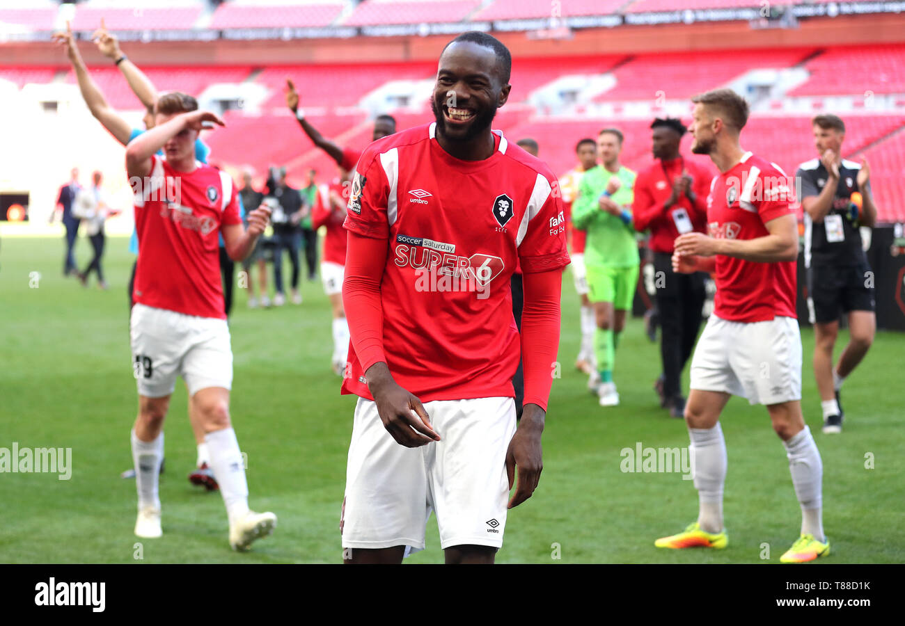 Salford City's Augustin Mafuta and team-mates celebrate after winning the Vanarama National League Play-off Final at Wembley Stadium, London. Stock Photo