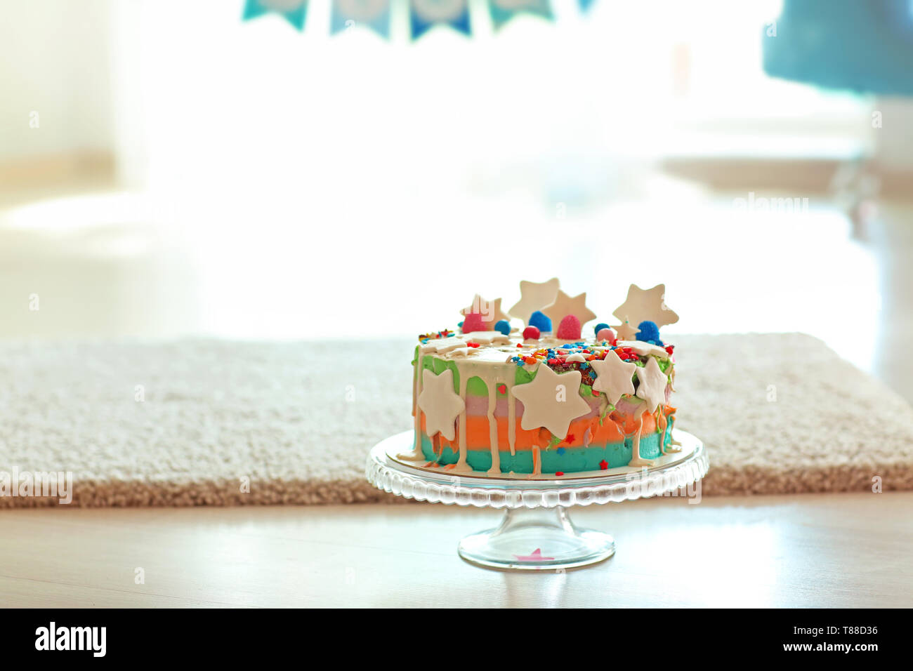 Stand with birthday cake on floor Stock Photo - Alamy