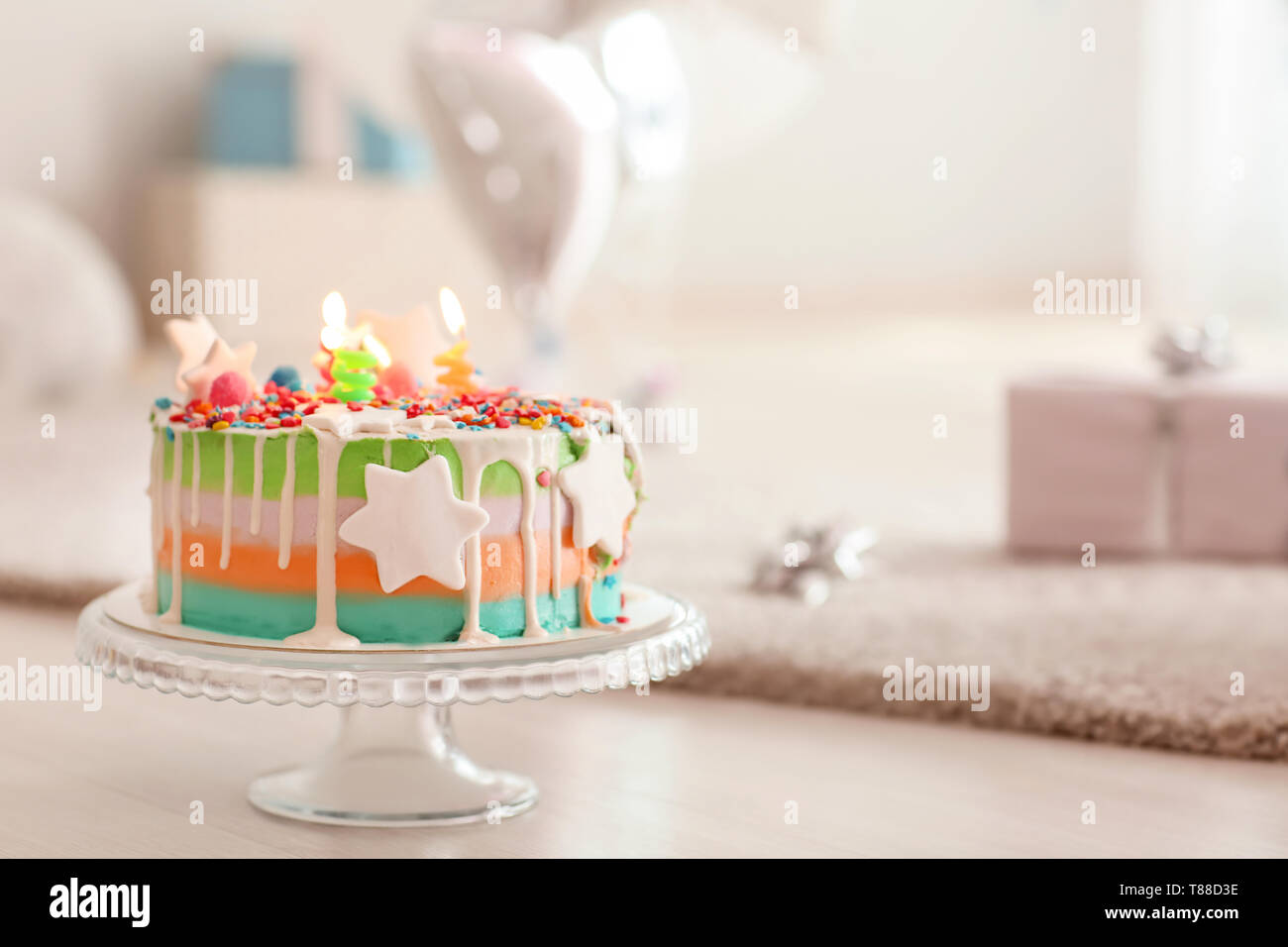 Stand with birthday cake on floor Stock Photo - Alamy