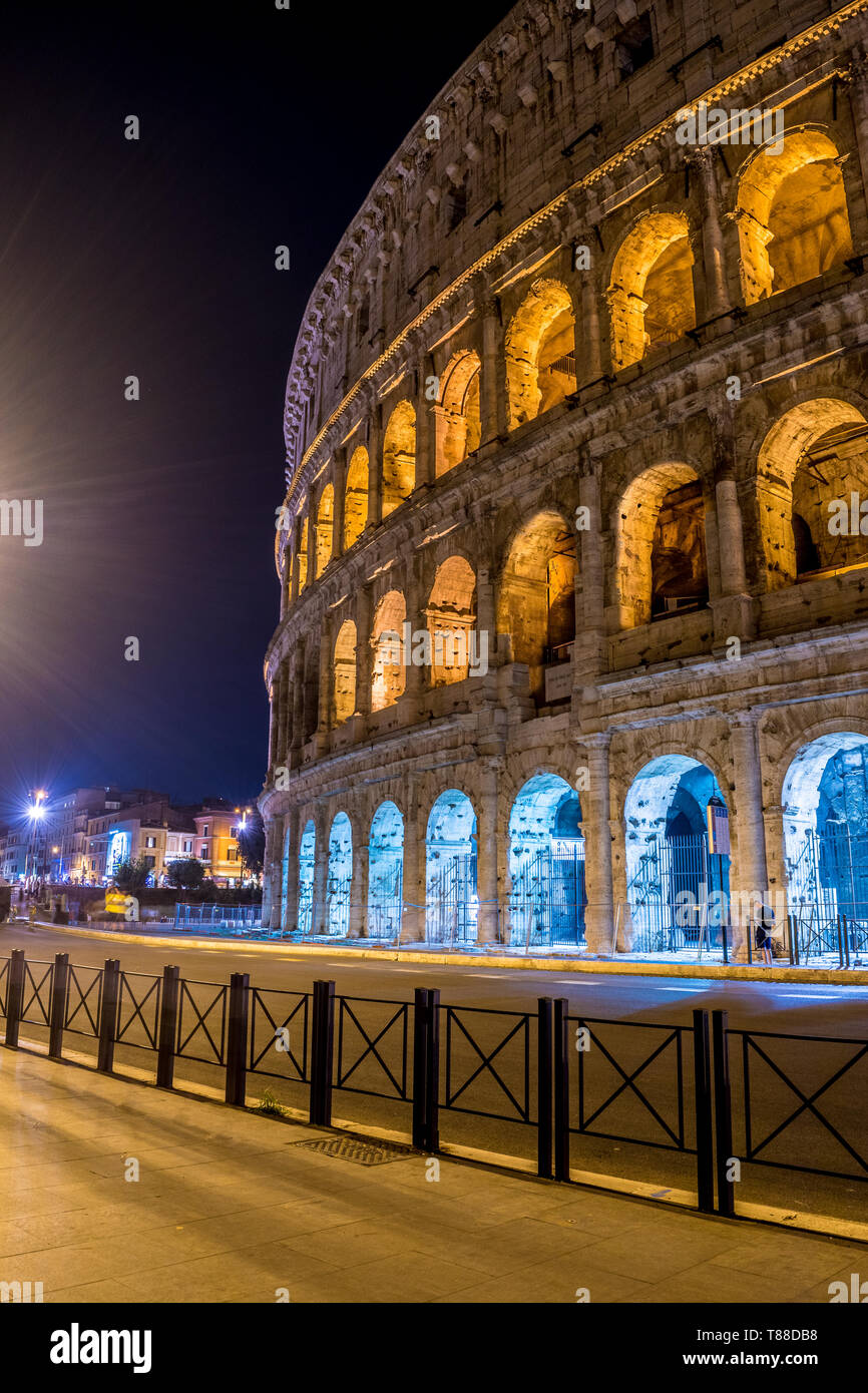 The side of the Great Roman Colosseum photographed on the street at night - Rome Italy Stock Photo