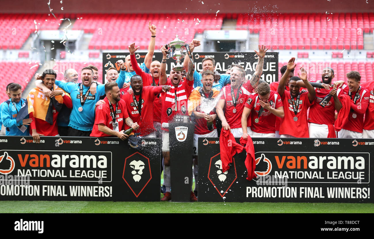 Salford City players celebrate with the trophy after winning the Vanarama National League Play-off Final at Wembley Stadium, London. Stock Photo