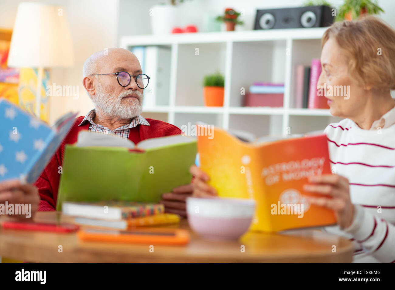 Pleasant senior people enjoying reading different books Stock Photo