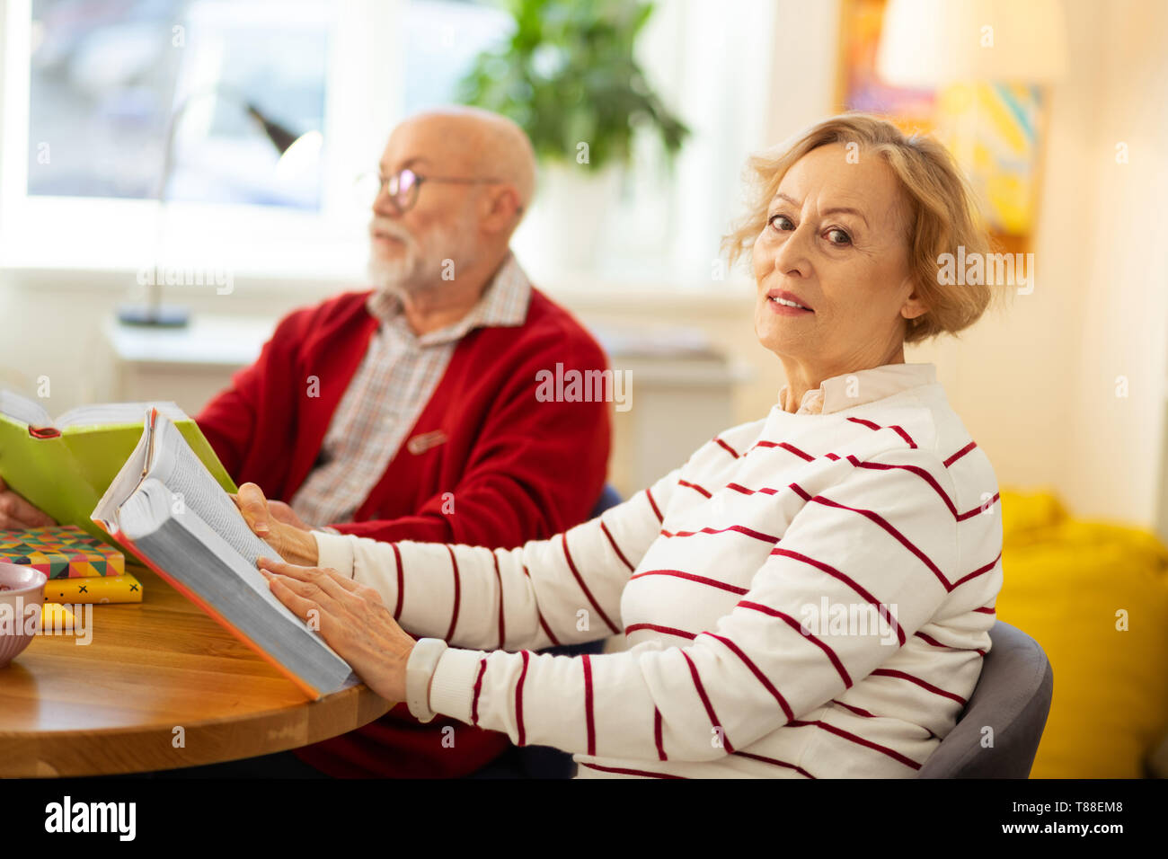Nice good looking woman sitting with a book Stock Photo