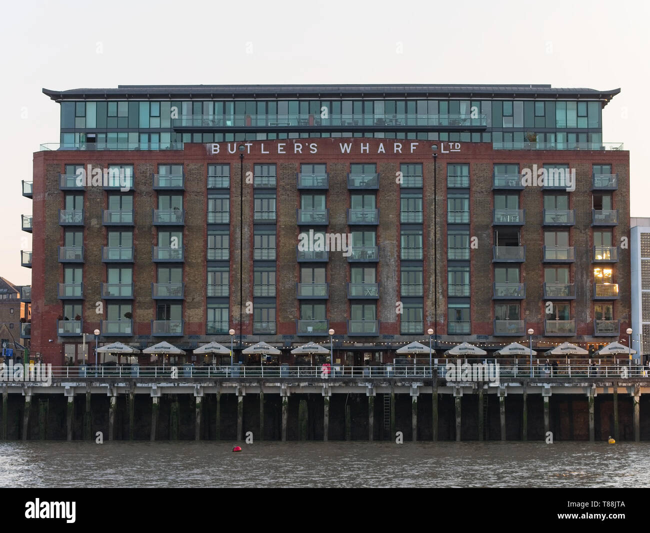 Historic Butler's Wharf building on the south bank of the River Thames at dusk, London, UK. Stock Photo