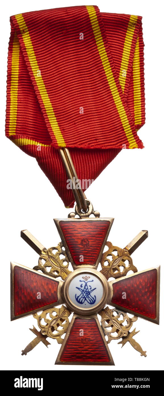 A 2nd Class Cross with Swords of the Order of St. Anne Cross of the order by maker Albert Keibel ('AK' and court purveyor punch in the vertical reverse cross arm) with combined inspection- and fineness designation for St. Petersburg and 56 zolotniki (583 parts gold) before 1908 (head faces left). On a slender original ribbon. Width 44.2 mm. Weight 19.6 g. historic, historical, medal, decoration, medals, decorations, badge of honour, badge of honor, badges of honour, badges of honor, 20th century, Additional-Rights-Clearance-Info-Not-Available Stock Photo