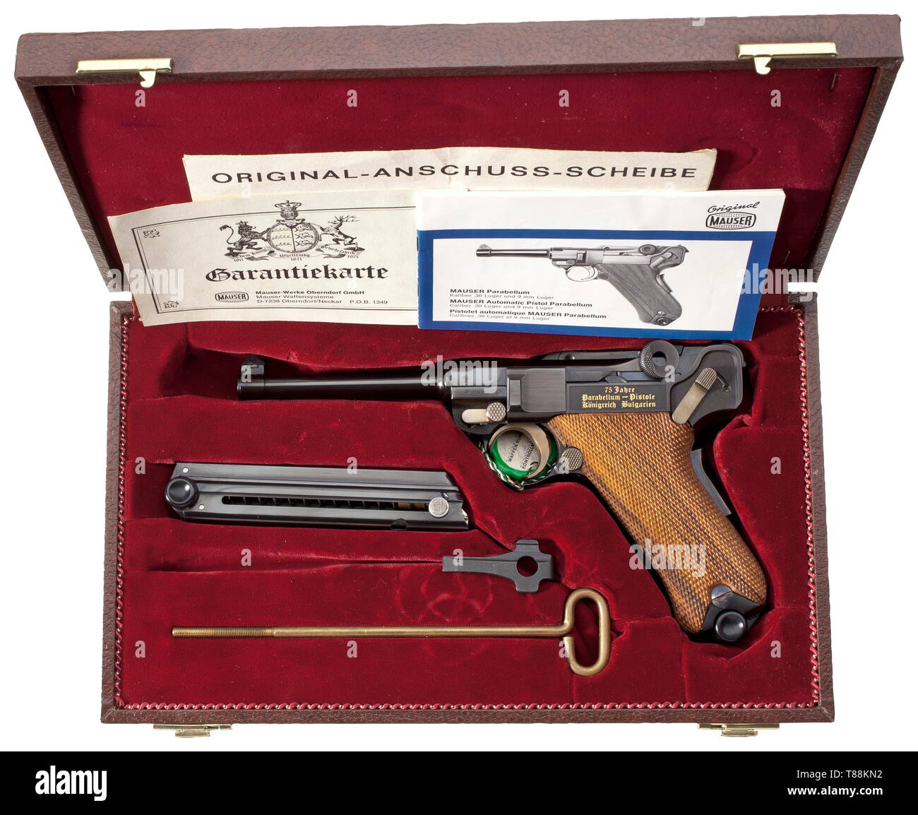 A Mauser Parabellum, commemorative model 'Königreich Bulgarien', in casket Cal. 7.65 Parabellum, no. 185/250B. Bright bore, length 120 mm. Proof-marked 1977. Grip safety. Safety and extractor marked in Cyrillic. On chamber etched engraving of Bulgarian coat of arms, on front toggle link 'DWM' in gold inlay. On left side of frame inlaid in gold '75 Jahre / Parabellum - Pistole / Königreich Bulgarien'. Complete black highly polished finish. Grip frame partially matted on the side. Operational parts strawed. Walnut grip panels. Magazine. Comes in da, Additional-Rights-Clearance-Info-Not-Available Stock Photo