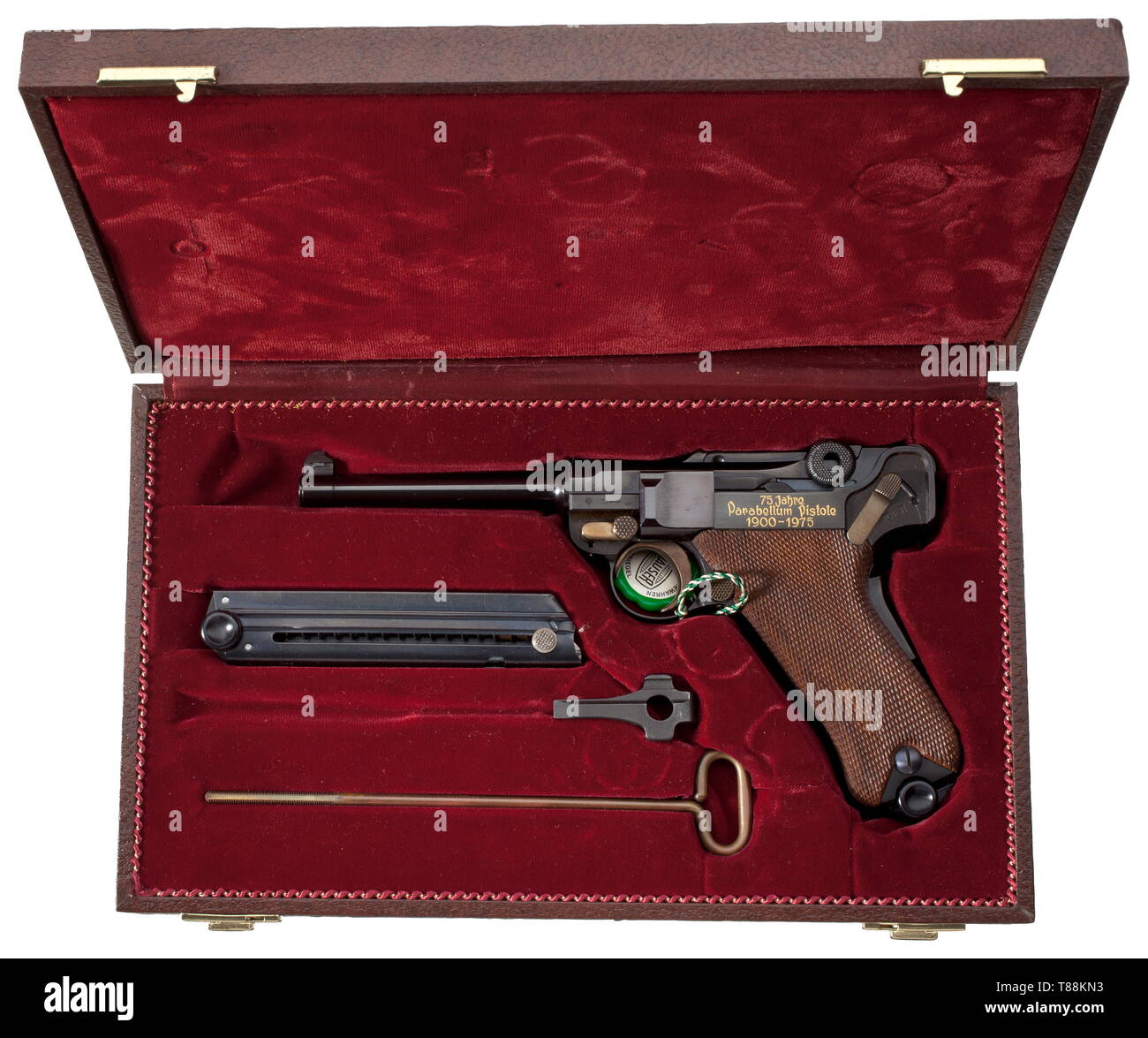 A Mauser Parabellum, commemorative model '75 Jahre Parabellum-Pistole', in casket Cal. 7.65 Parabellum, no. 185/250. Bright bore, length 120 mm. Proof-marked 1973(!). Grip safety. On chamber etched engraving of Swiss cross inside corona, on front toggle link Mauser barrel. On left side of frame inlaid in gold '75 Jahre / Parabellum - Pistole / 1900 - 1975'. Complete black highly polished finish. Operational parts strawed. Walnut grip panels. Magazine. Comes in dark brown Mauser imitation leather casket, dimensions 32 x 19 x 6 cm, lined with wine-, Additional-Rights-Clearance-Info-Not-Available Stock Photo