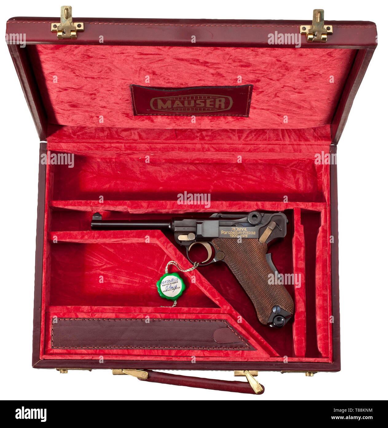 A Mauser Parabellum, commemorative model '75 Jahre Parabellum-Pistole', in its case Cal. 7.65 Parabellum, no. 001/250. Bright bore, length 120 mm. Proof-marked 1973. Grip safety. On chamber etched engraving of Swiss cross inside corona, on front toggle link Mauser barrel. On left side of frame inlaid in gold '75 Jahre / Parabellum - Pistole / 1900 - 1975'. Complete black highly polished finish. Operational parts strawed. Walnut grip panels. Magazine. Comes with wine-red leather case, dimensions 36 x 26 x 7 cm, lined with red velvet. Two case keys, Additional-Rights-Clearance-Info-Not-Available Stock Photo