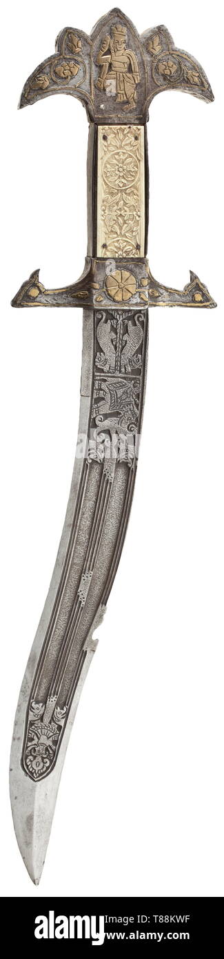 An Indian ceremonial dagger, circa 1900 Curved single-edged blade with multiple fullers and ridged double-edged point. Etched Damascus decorations on both sides depicting chiselled beasts and gods. Iron brass-inlaid pommel embellished with flowers and figures, the cross-guard with finely carved, ivory inlaid grip scales. Length 56.5 cm. historic, historical, 20th century, Additional-Rights-Clearance-Info-Not-Available Stock Photo