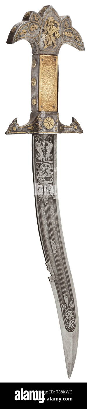 An Indian ceremonial dagger, circa 1900 Curved single-edged blade with multiple fullers and ridged double-edged point. Etched Damascus decorations on both sides depicting chiselled beasts and gods. Iron brass-inlaid pommel embellished with flowers and figures, the cross-guard with finely carved, ivory inlaid grip scales. Length 56.5 cm. historic, historical, 20th century, Additional-Rights-Clearance-Info-Not-Available Stock Photo