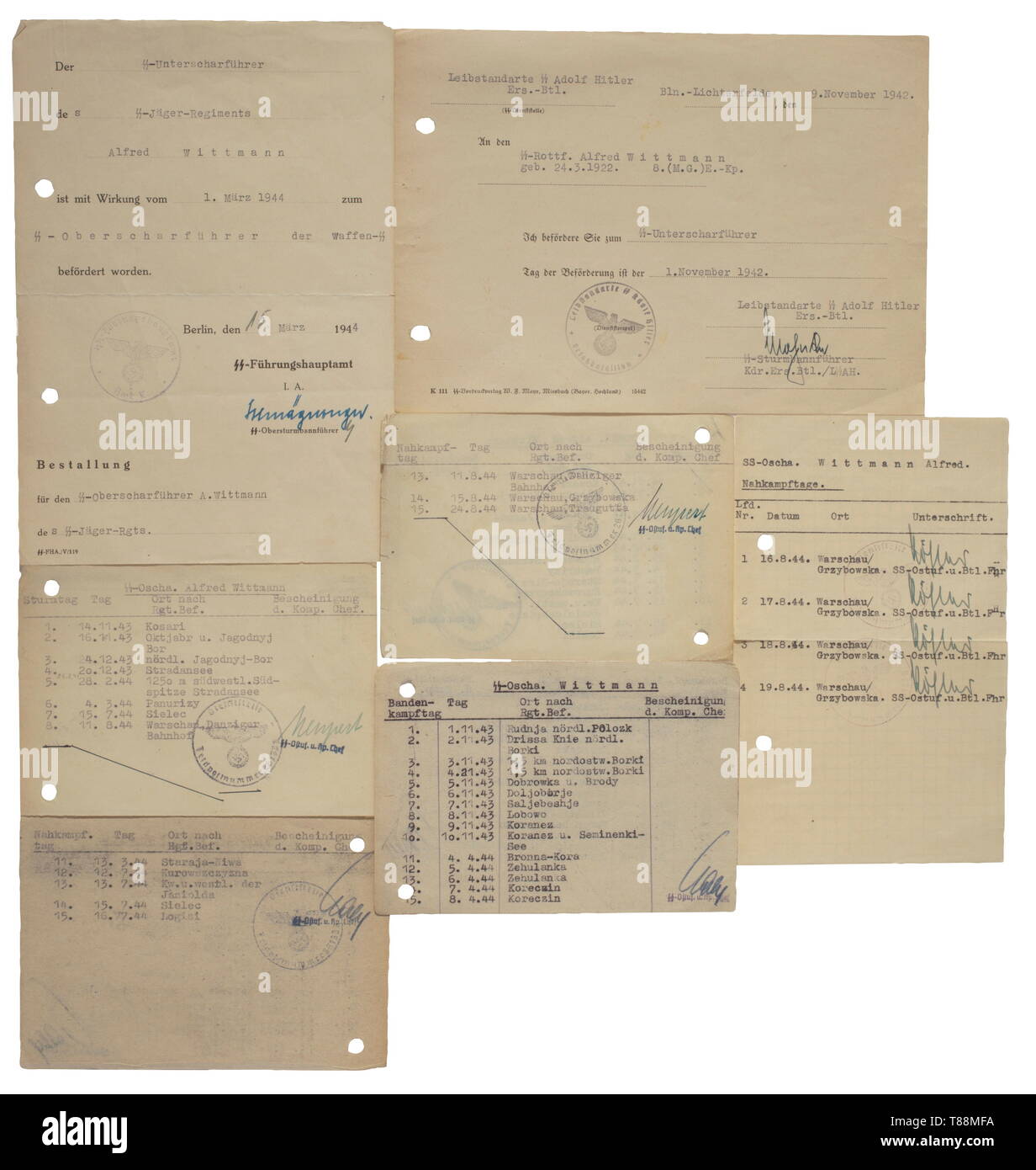 A grouping of Alfred Wittmann SS-Jäger Battalion 501 - Warsaw uprising Award documents for the Iron Cross 1st Class, issued 25 March 1944 by '10./SS-Jg.Rgt.' with original signature of v. Strachwitz, for the Eastern Front Medal issued by '3. SS-Jäger Btl. 501', for the Wound Badge in Black and in Silver issued by 'Gen.-Komp./LSSAH' and 'Jg.Batl. 501' respectively with original signature of Mohnke and a Chief Staff Doctor. Promotion documents to Unter- as well as Oberscharführer, five attestations for 27 days engaging in anti-partisan operations, fifteen close combat days an, Editorial-Use-Only Stock Photo