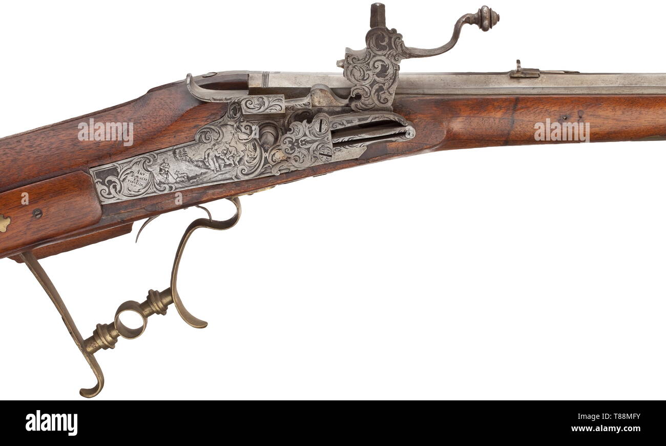 A Bavarian wheellock rifle, Antoni Zurschenthaler, Dingolfing, circa 1720 Slightly swamped, octagonal barrel of earlier date with eight-groove rifled bore in 13 mm calibre with dovetailed sights. At the breech stamped 'MF' and dated '1681'. (Replaced) wheellock chiselled with tendrils and figures and internal wheel, the lockplate with signature 'ANT. ZURSCHENTHALLER'. Defective double set trigger. Smooth walnut full stock with horn nose and patchbox. The trigger guard is a non-matching replacement, later wooden ramrod. The stock with lining near , Additional-Rights-Clearance-Info-Not-Available Stock Photo