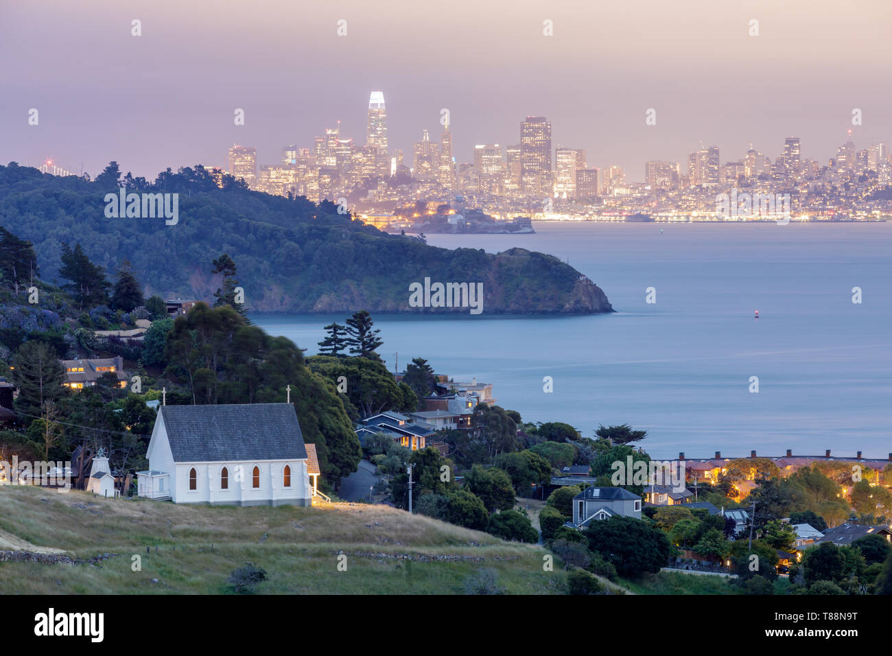 Scenic views of Old St Hillary's Church, Angel Island, Alcatraz Prison, San Francisco Bay and San Francisco Skyline at dusk. Stock Photo
