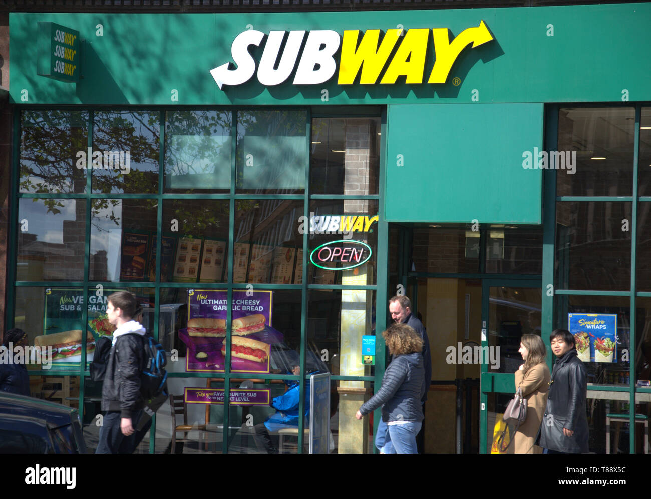 Exterior view of Subway shop in Piccadilly Gardens, Manchester, uk, as members of the public walk past Stock Photo