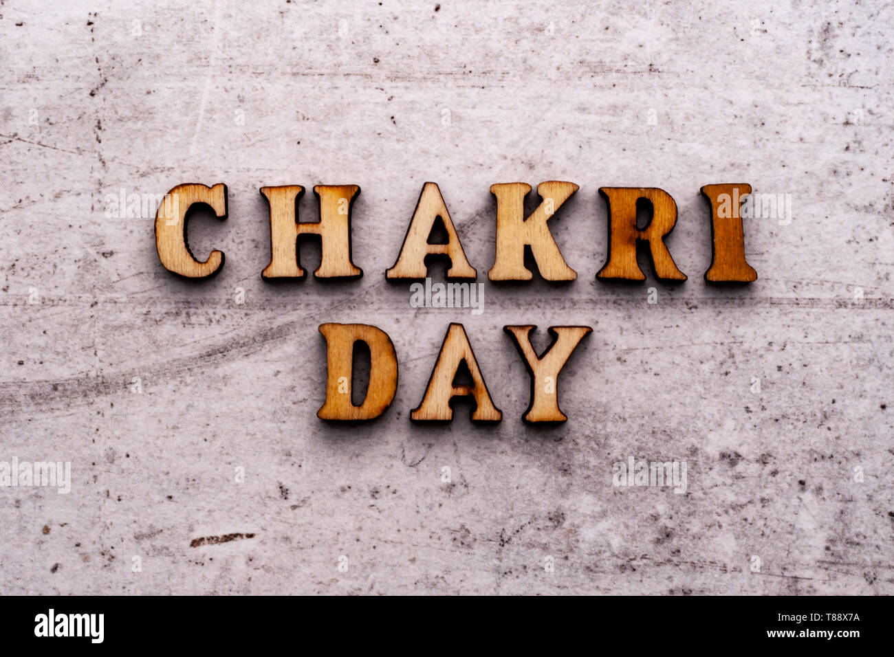 Inscription CHAKRI DAY in wooden letters on a light background. Stock Photo