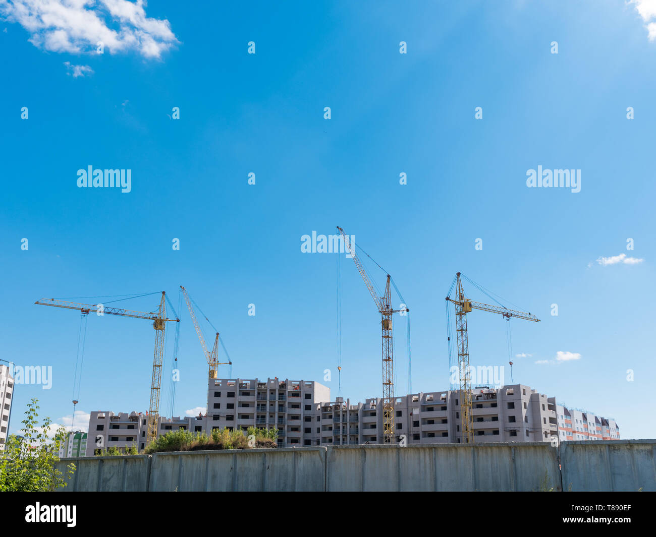 Construction site with many cranes against the sky Stock Photo - Alamy