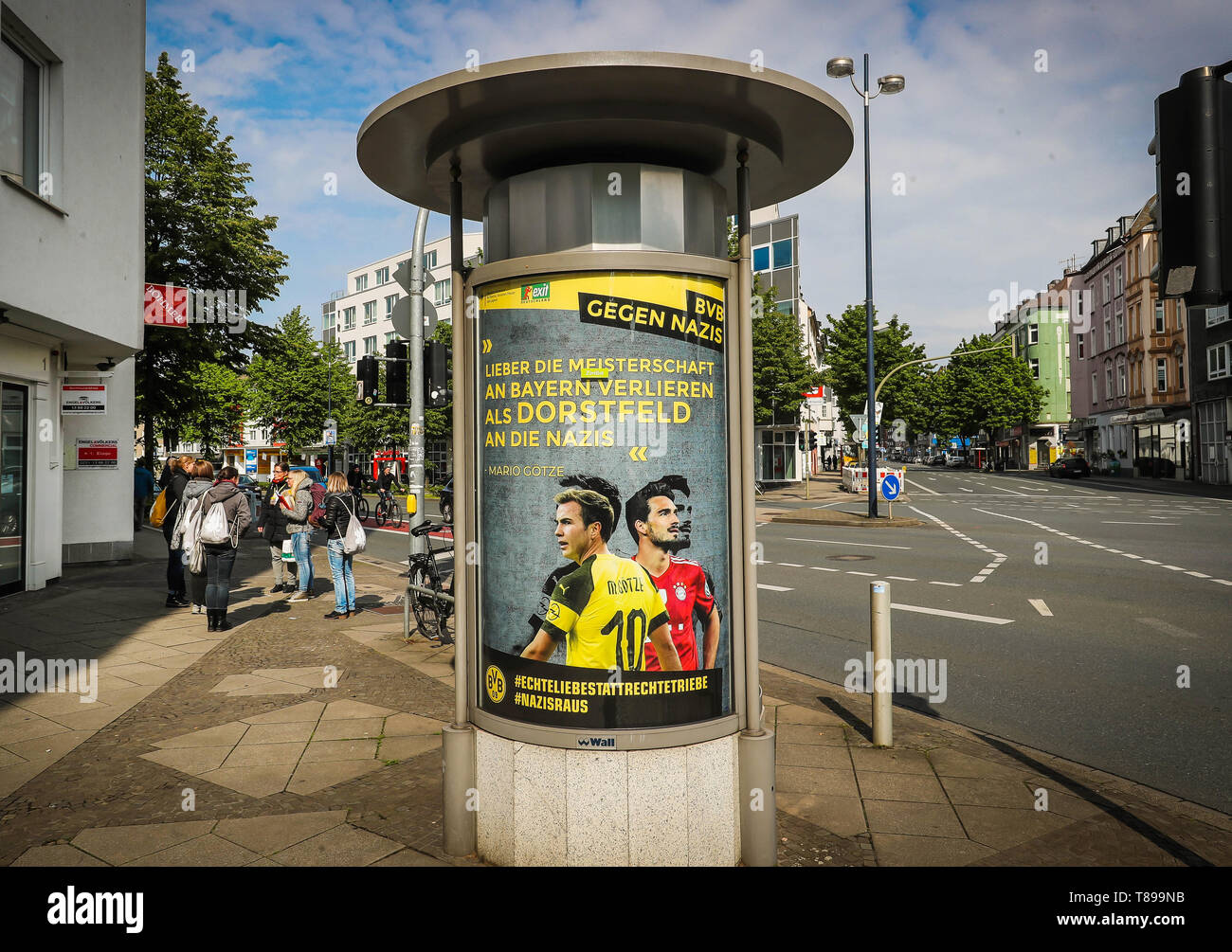 11 May 2019, North Rhine-Westphalia, Dortmund: An illegally hung poster with photos of BvB players and the inscription 'Lieber die Meisterschaft an Bayern verlieren als Dorstfeld an die Nazis' can be seen on an advertising pillar on the way to the stadium. Unknown persons had hung up posters with partly drastic confessions against Nazis in advertising showcases at several locations, which were attributed to players and the coach of Borussia Dortmund. Photo: Stephan Schütze/dpa - ATTENTION: Only for editorial use in connection with the current reporting on the poster campaign and only with comp Stock Photo
