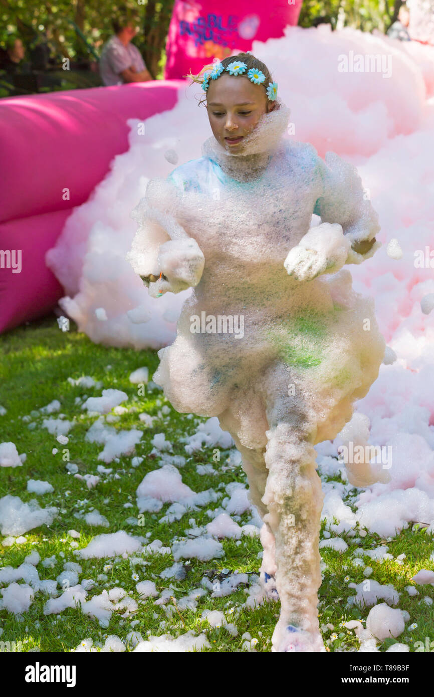 Weymouth, Dorset, UK. 12th May 2019. Weldmar's last ever Bubble Rush takes place at Weymouth to raise funds for the charity. Participants have fun getting covered in foam, running through bubbles of different colours. Credit: Carolyn Jenkins/Alamy Live News Stock Photo