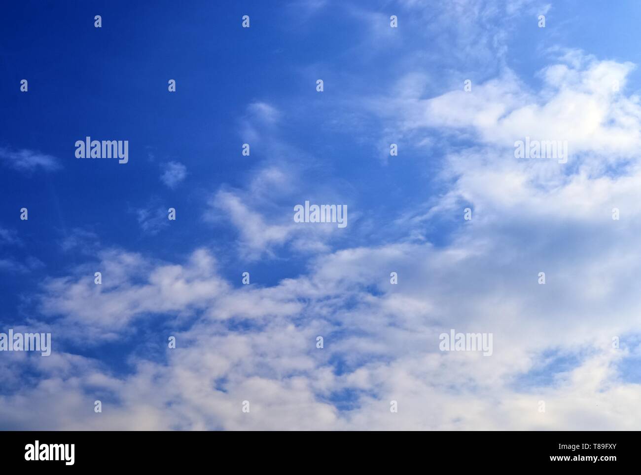 Beautiful white cloud formations in a deep blue sky on a sunny day ...