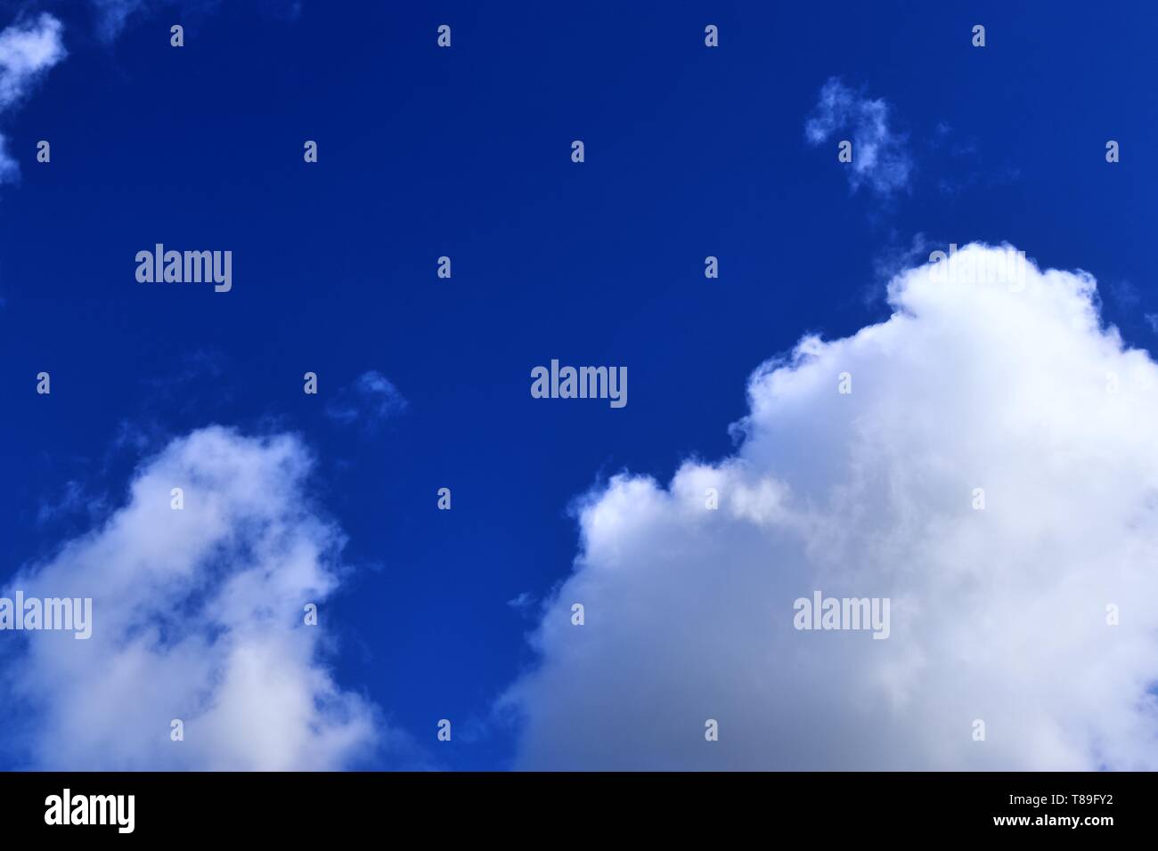 Beautiful white cloud formations in a deep blue sky on a sunny day ...