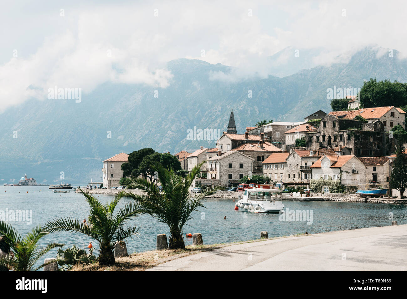 Beautiful view of the old coastal town of Perast in Montenegro with beautiful architecture, the sea and boats on the background of the mountains. Stock Photo