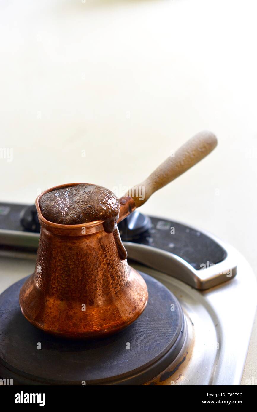 Boiling Coffee, Turkish, stove top in a copper jezve Stock Photo Alamy
