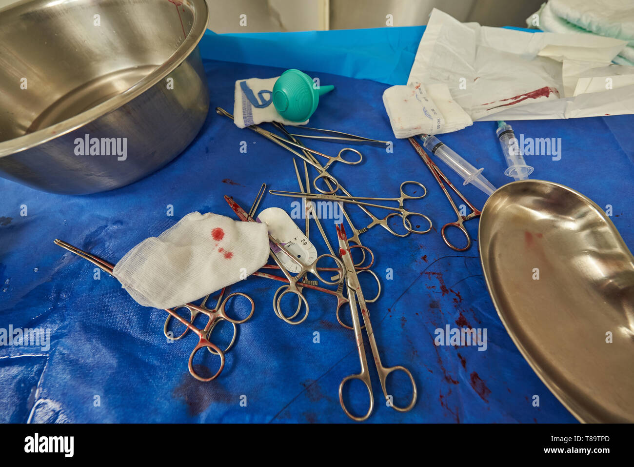 Dirty of blood medical table after operation. Surgery equipment on table Stock Photo