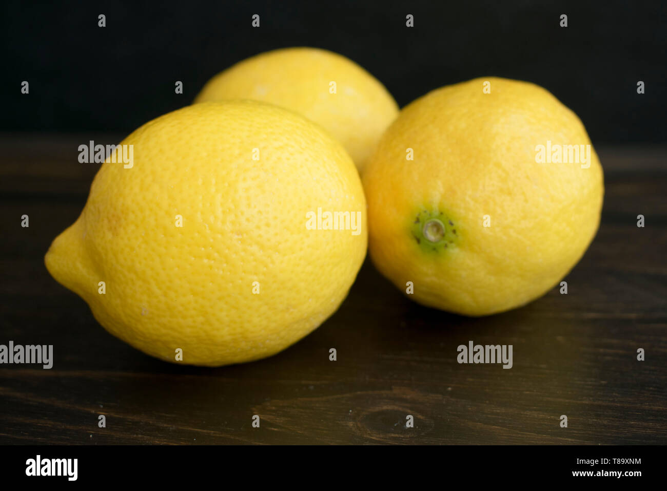 Lemons on a Dark Wood Background Stock Photo