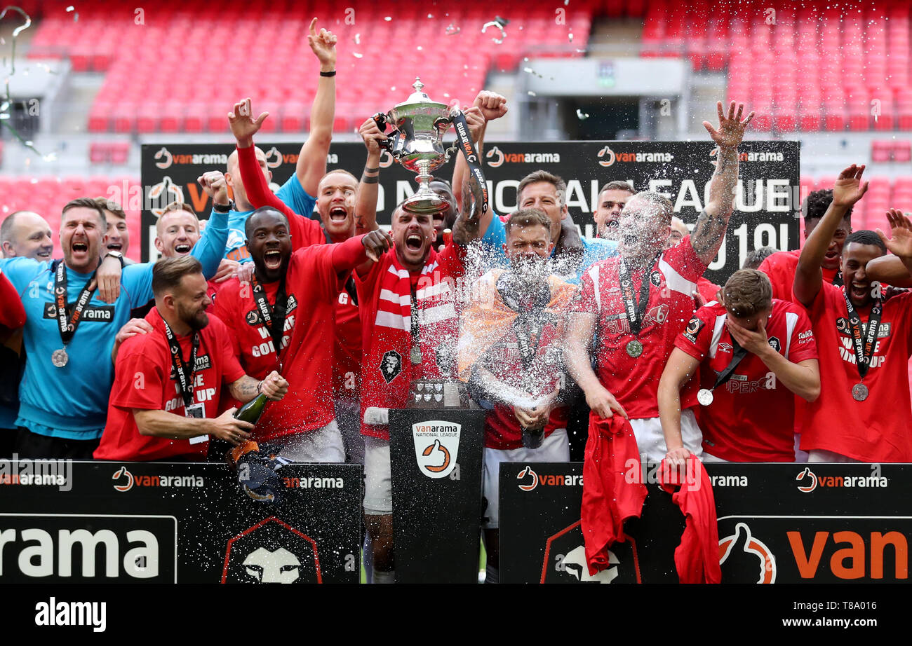 salford-city-players-celebrate-with-the-trophy-after-winning-the
