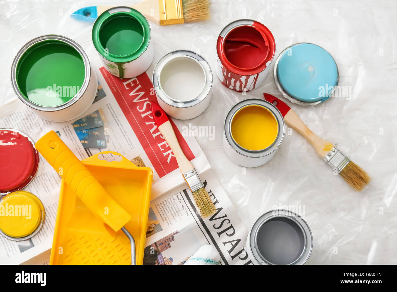 Paint cans with tools on table, top view Stock Photo