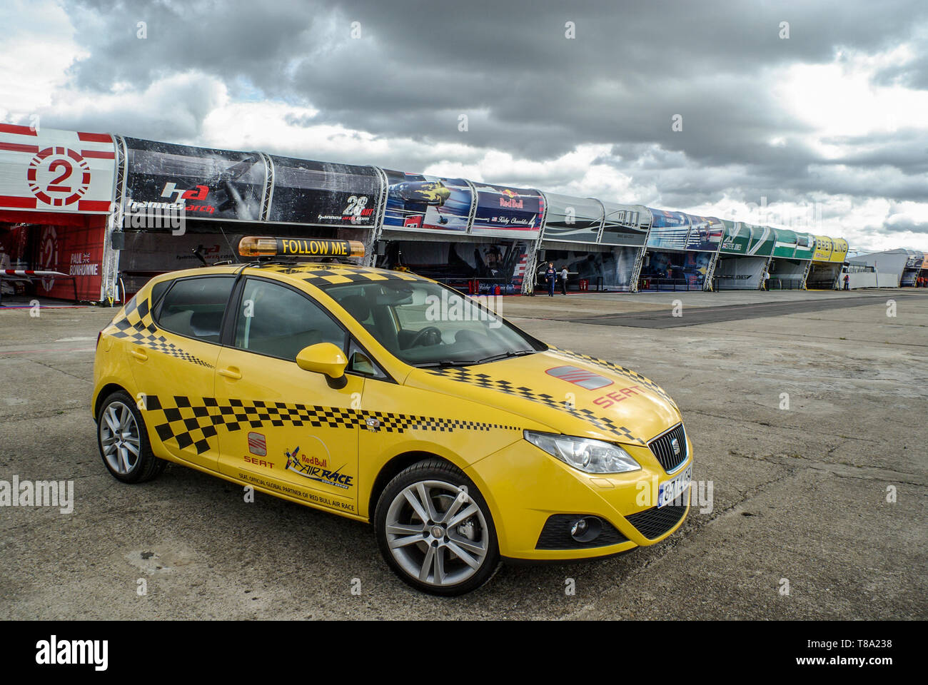 Seat Ibiza Follow Me car at the Red Bull Air Race pits with race plane hangars beyond with planes. London round of the air race series. Sponsorship Stock Photo