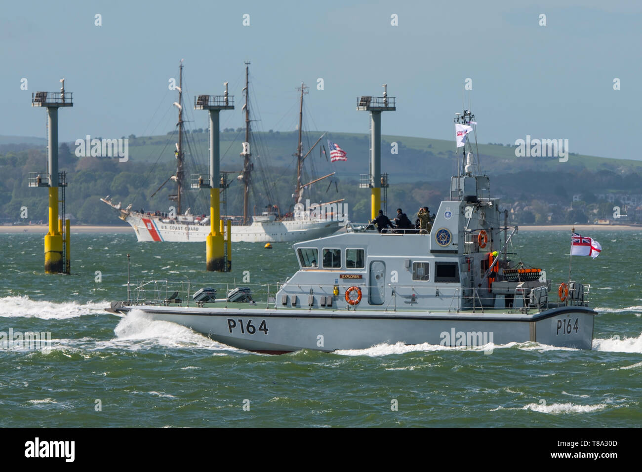 The Royal Navy Archer Class patrol boat HMS Explorer (P164) in The Solent, UK for sea training on 25/4/19 with the USCGC Eagle in the background. Stock Photo