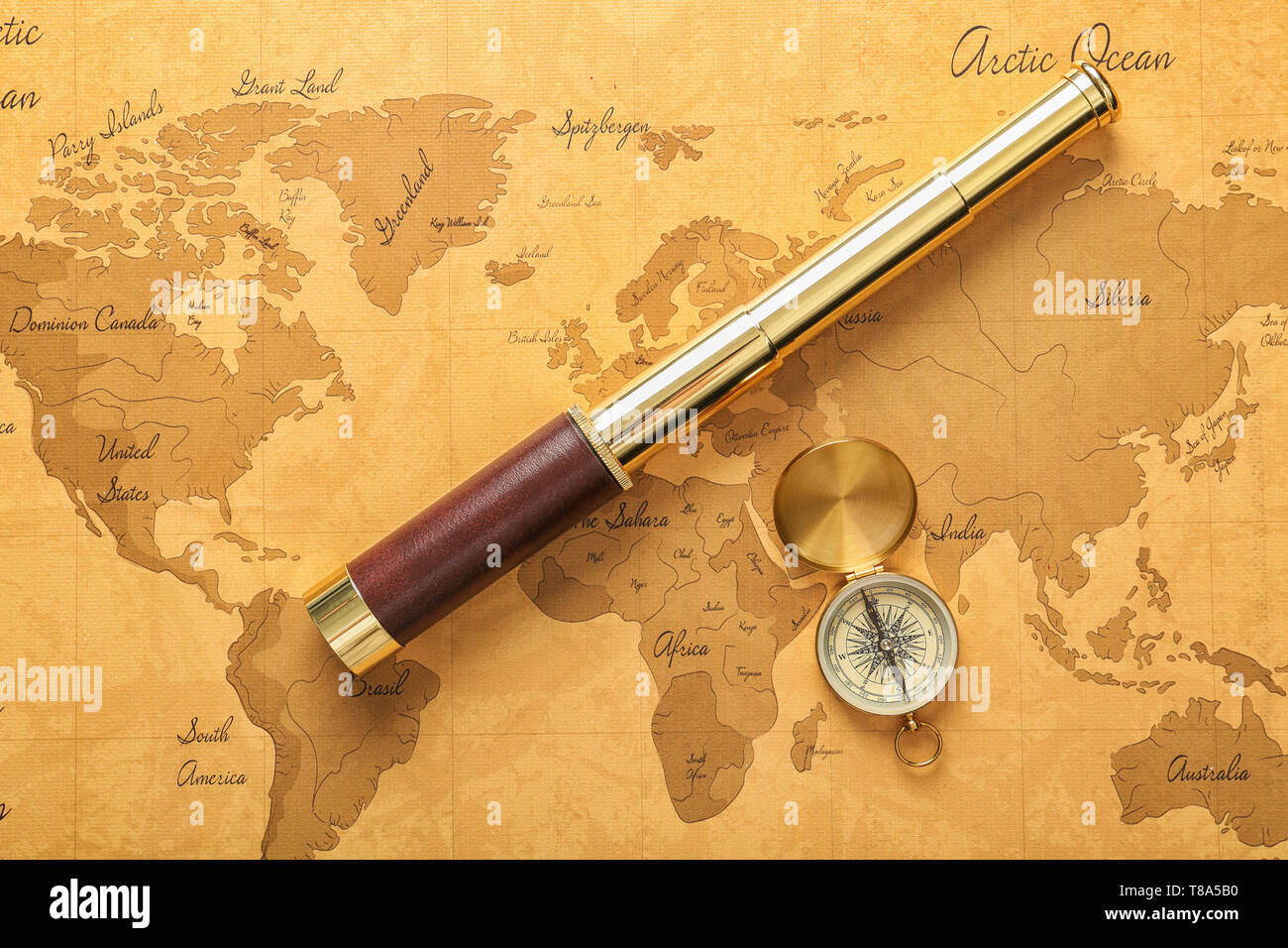 Vintage compass with spyglass on world map Stock Photo - Alamy
