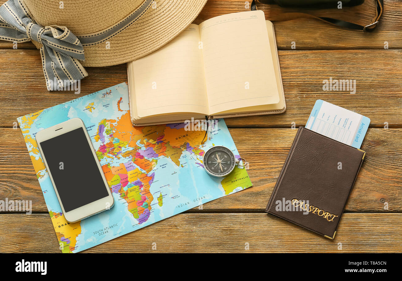 Composition with world map, compass and passport on wooden background. Travel planning Stock Photo