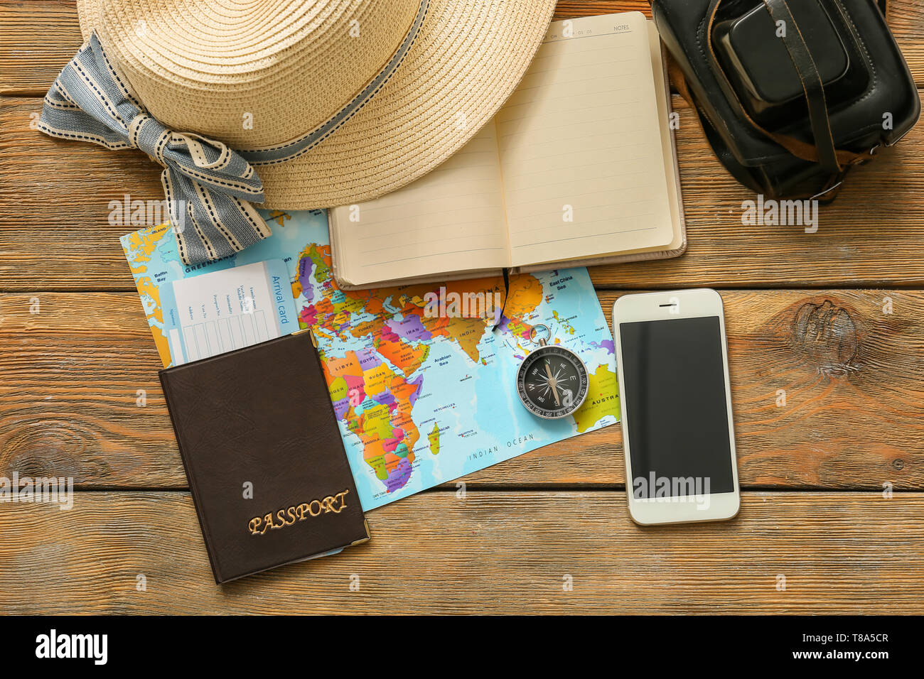 Composition with world map, compass and passport on wooden background. Travel planning Stock Photo