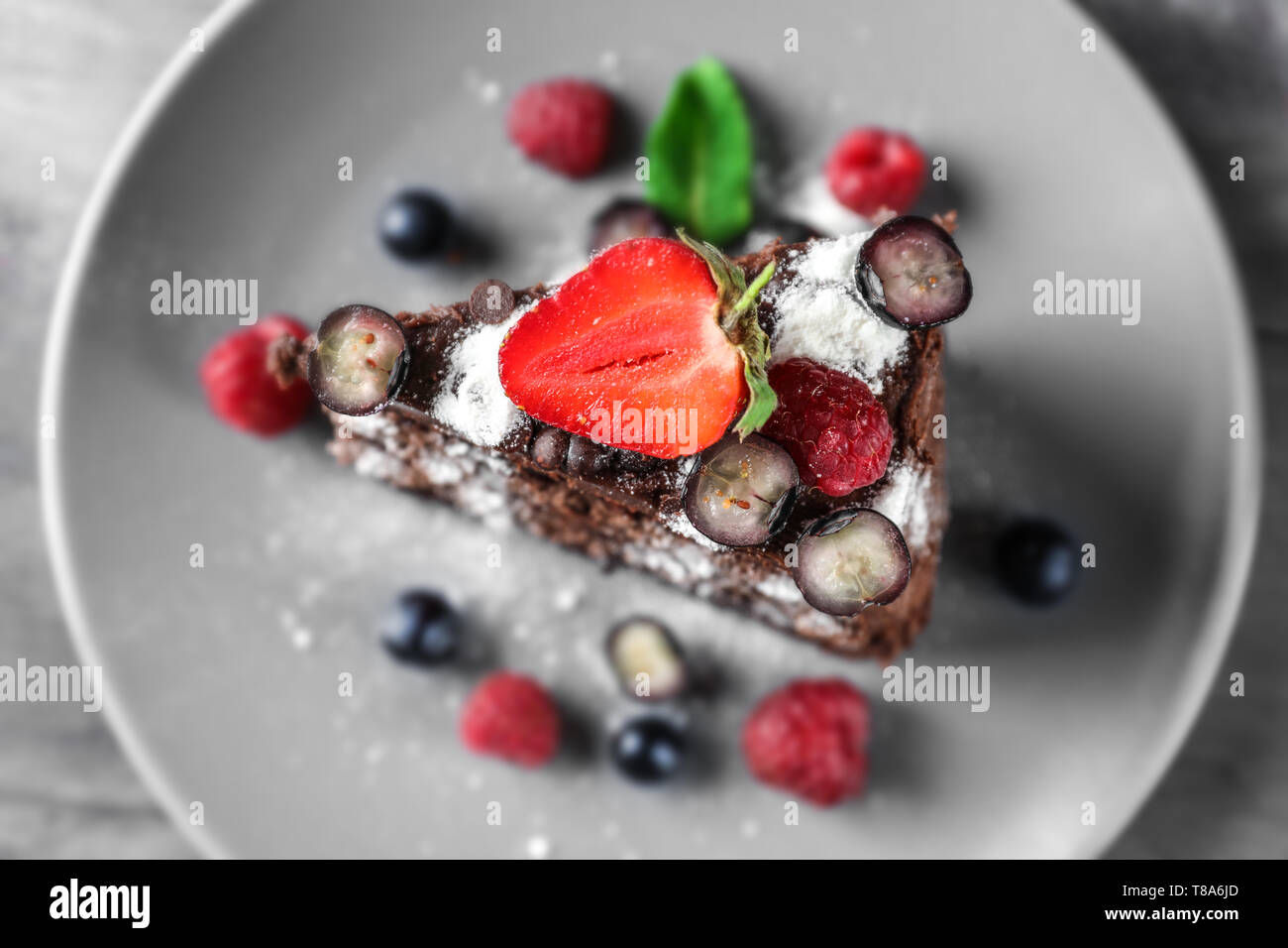 Piece of delicious chocolate cake with berries on plate Stock Photo - Alamy