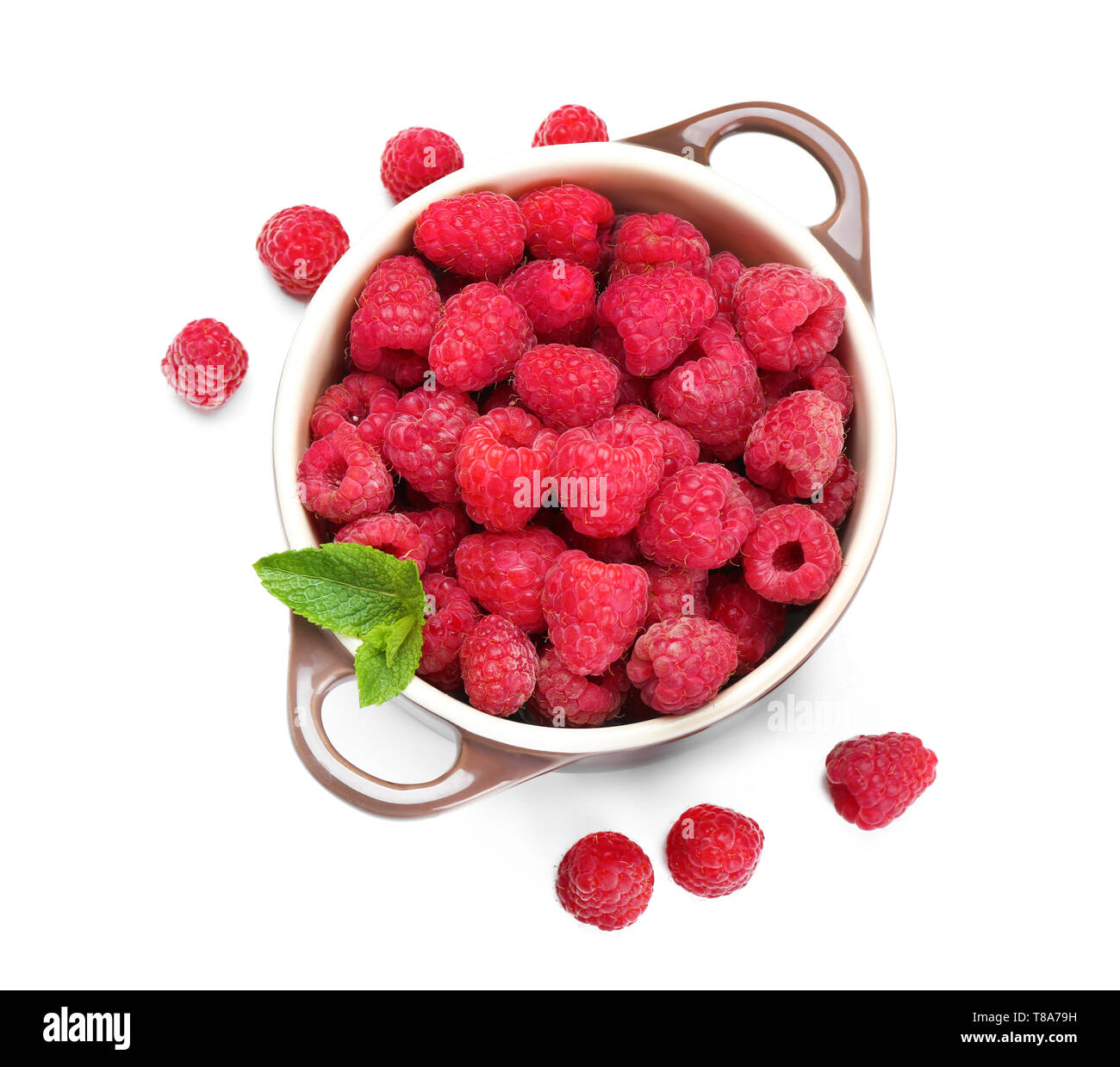 Pot with ripe raspberries on white background Stock Photo - Alamy