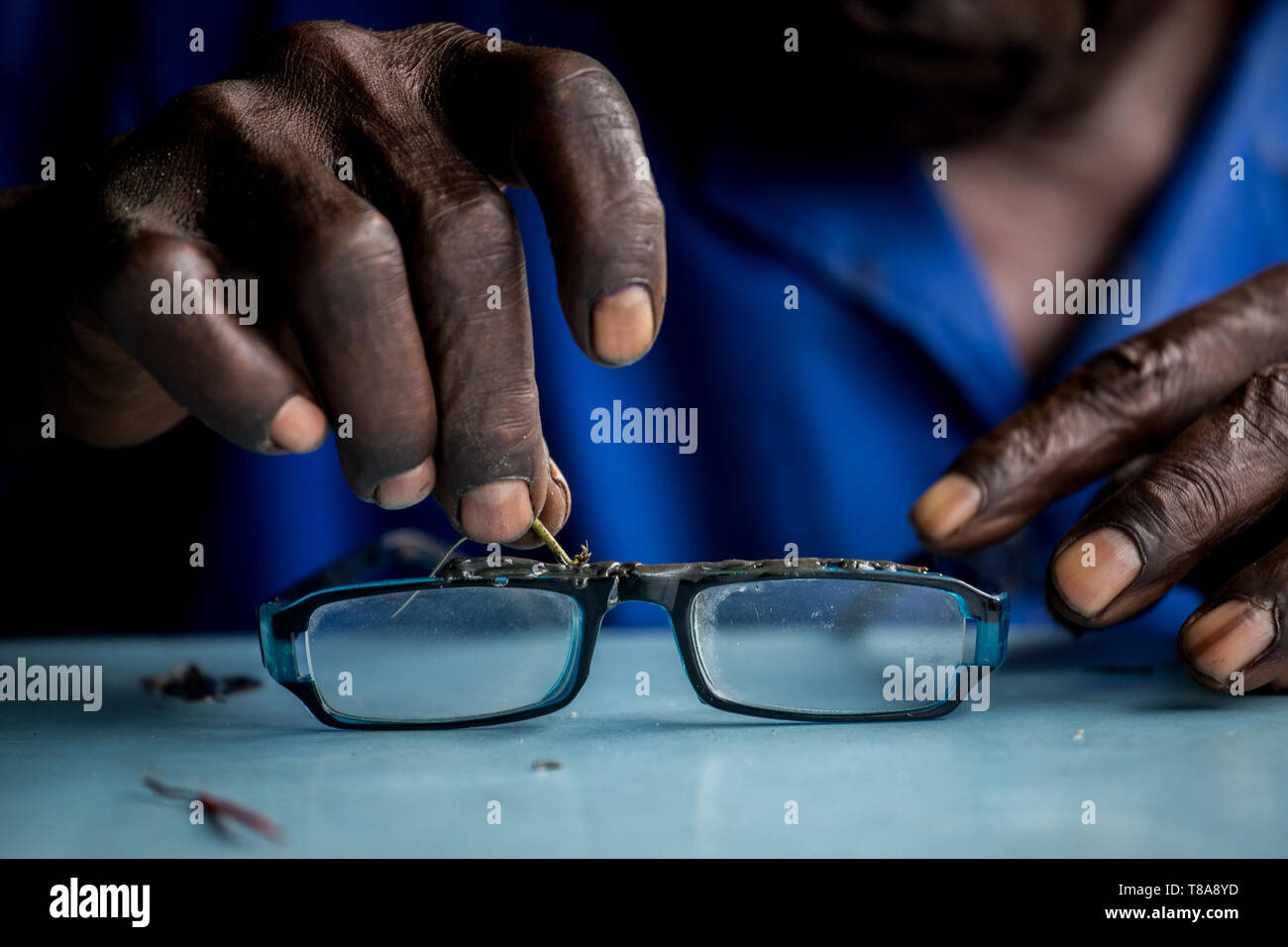 A man fixing a broken glass frame Stock Photo Alamy