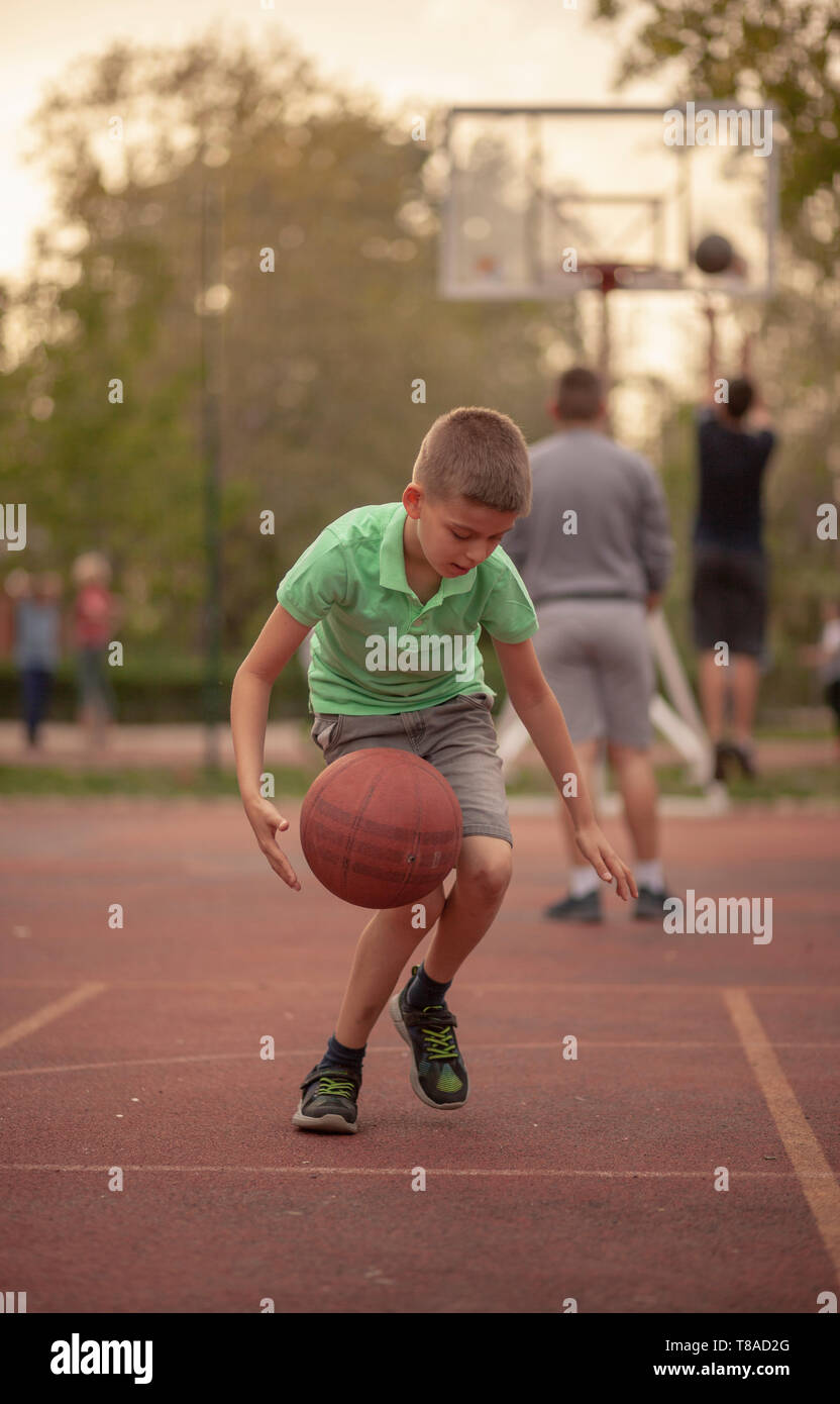 Boy dribbling basketball hires stock photography and images Alamy