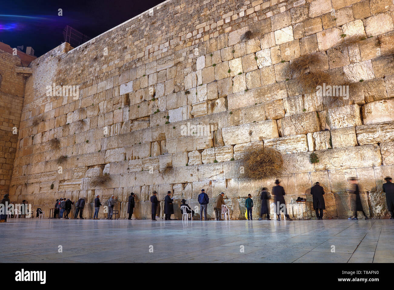 Praying at the Western 'Wailing' Wall of Ancient Temple in Jerusalem. The Wall is the most sacred place for all Jews in the world. Stock Photo