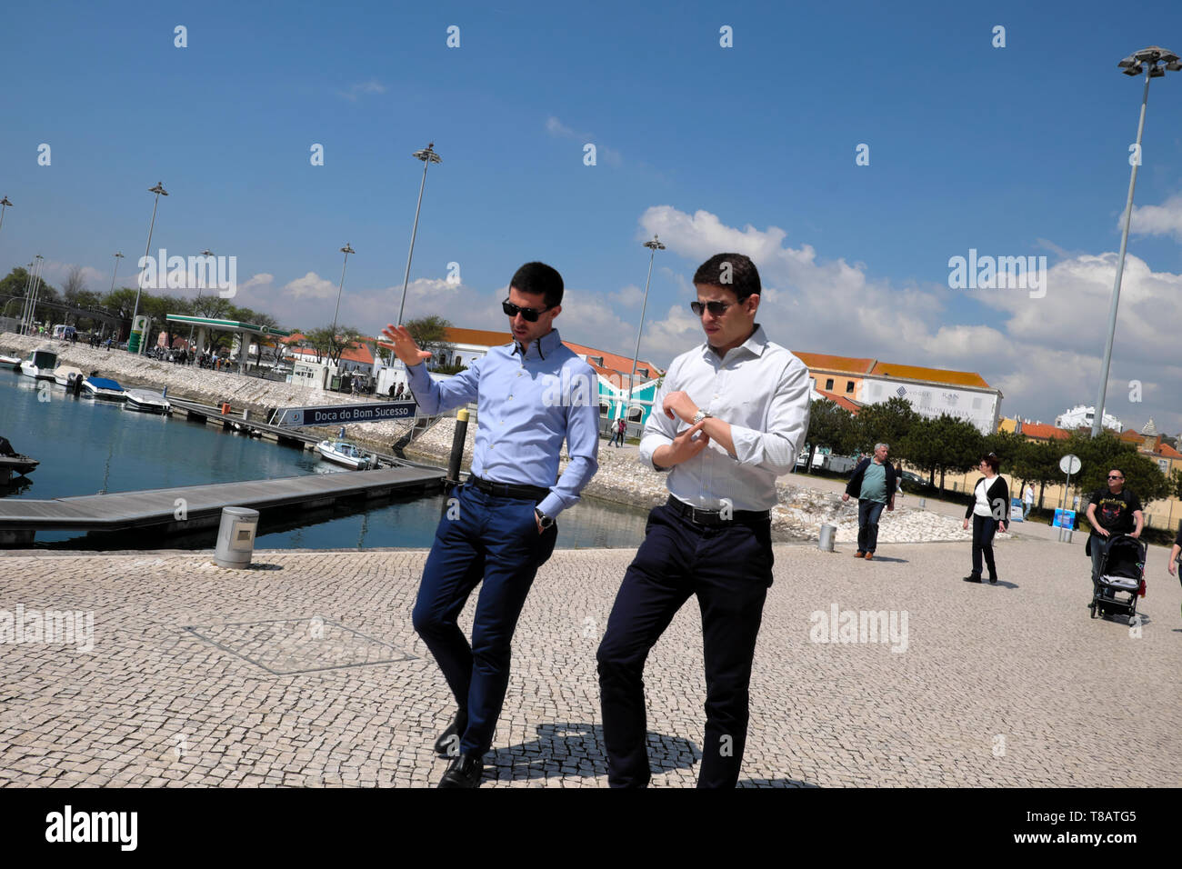 Young businessmen walking talking in conversation on the Doca de Belem marina at lunchtime in  Belem Lisboa Lisbon Portugal Europe EU  KATHY DEWITT Stock Photo