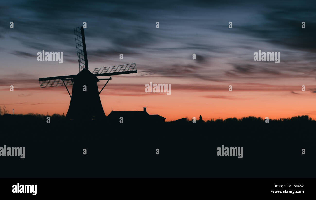 Silhouette of traditional Dutch windmill at sunset at sunset Stock ...