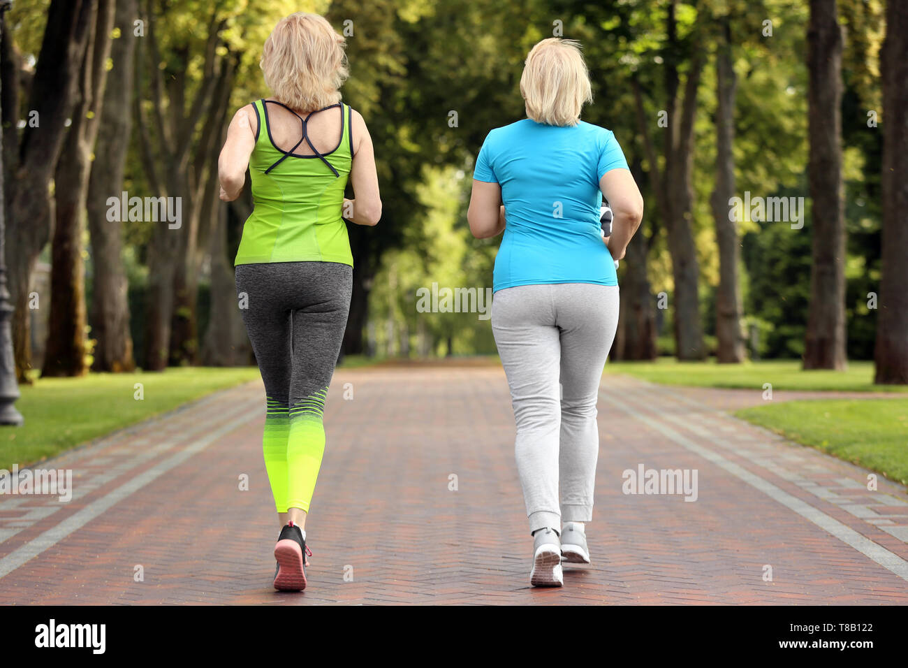 Sporty mature women training in park Stock Photo