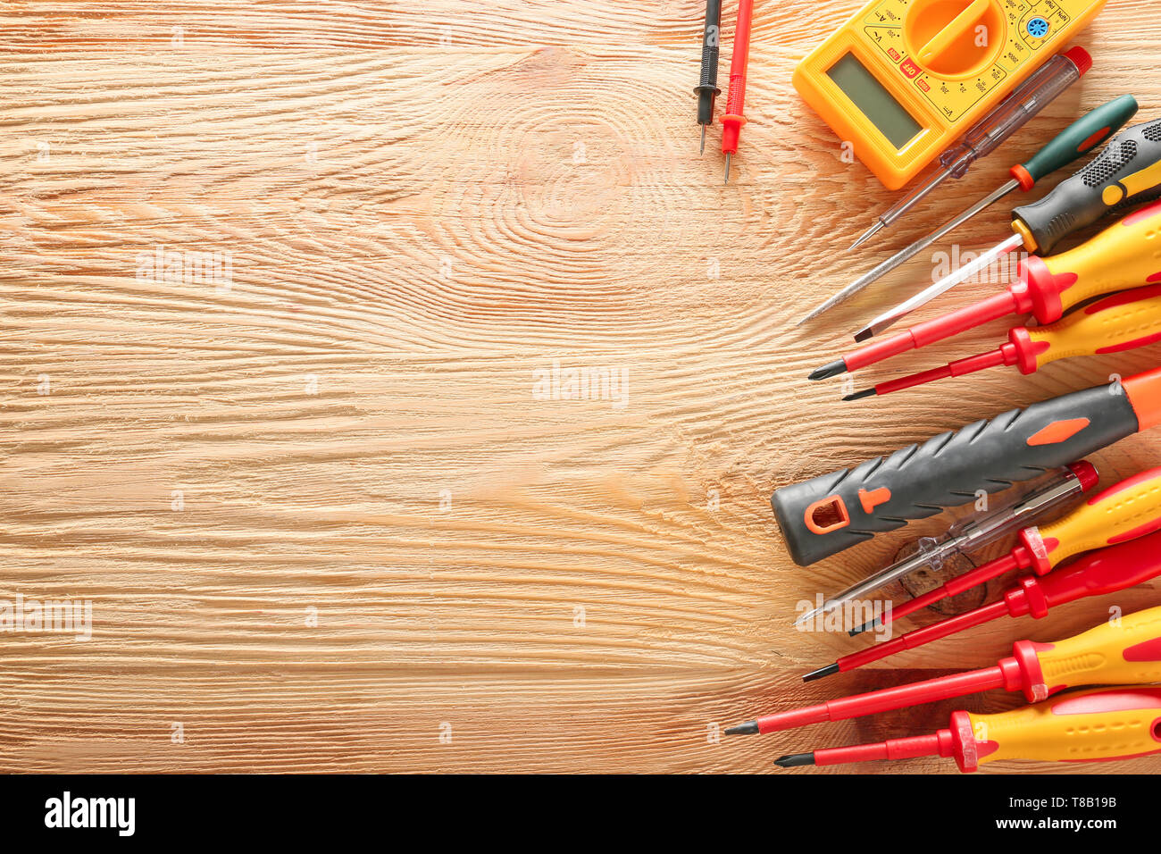 Different electrician's tools on wooden background Stock Photo